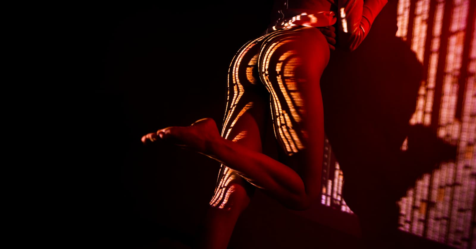 Light patterns projected on woman naked body.